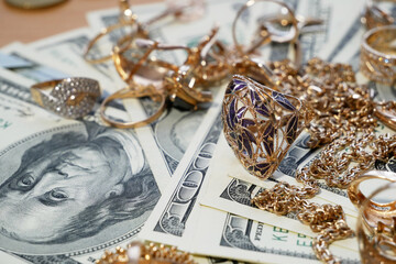 golden jewelry and stack of money, pawnshop concept