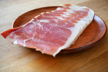 Slices Of Jamon On The Wooden Background