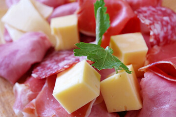 Cold Smoked Meat Plate, antipasto set platter wooden plate. Cold smoked meat plate with sliced ham, prosciutto, bacon. Copy space. Top view