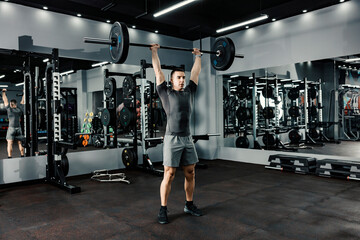Fototapeta na wymiar A bodybuilder lifting weights in a gym. Deadlift