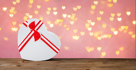 Gift box heart on a background of bokeh hearts