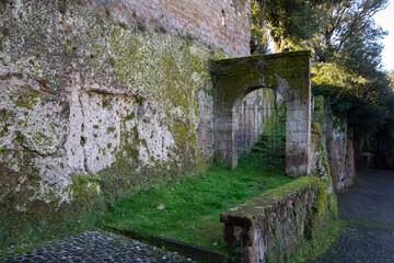 Fototapeta na wymiar Stone wall and small entrance of The Villa Savorelli in Sutri ,Italy.
