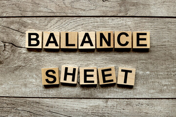 BALANCE SHEET. text on wooden blocks on a wooden background