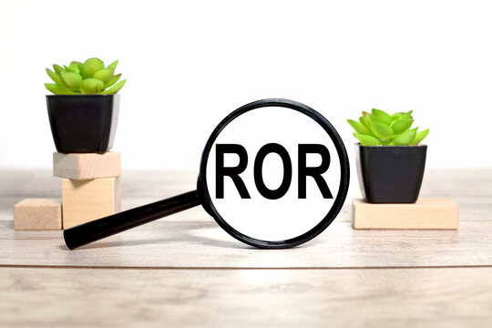 ROR. magnifier with place to insert text. on wooden background.business concept