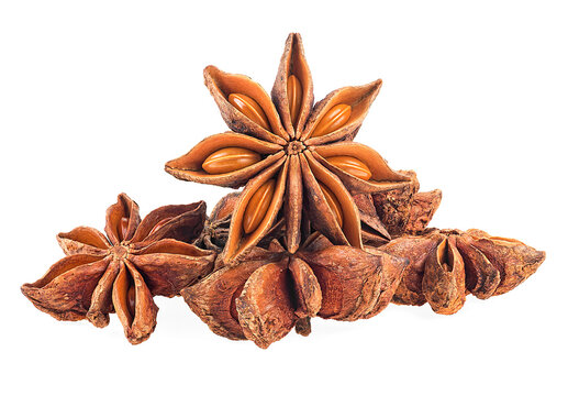 Pile of anise star spice fruits and seeds isolated on a white background