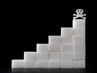 sugar cube stairs with death skull on black background, excessive sugar consumption can be deadly, concept image