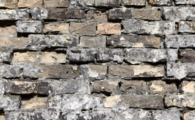 Weathered painted old brick wall background. Brickwork paint.