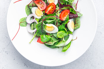 salad quail egg tomato, lettuce mix leaves healthy meal food snack on the table copy space food background rustic top view keto or paleo diet veggie vegetarian food no meat