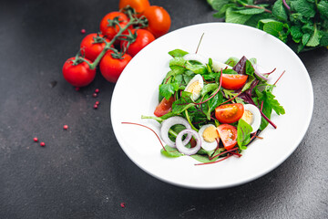 salad quail egg tomato, lettuce mix leaves healthy meal food snack on the table copy space food background rustic top view keto or paleo diet veggie vegetarian food no meat