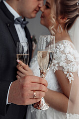 The newlyweds raise their glasses on a significant day.