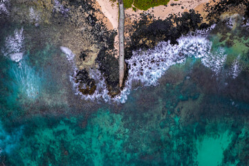 Aerial view of a fishing pier and the waves crashing on the south coast of Mauritius island