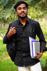 Young student image near college campus giving SMILE in camera