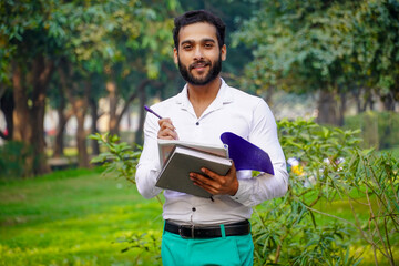 Fototapeta premium Writing something Indian boy images college student Indian