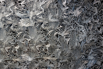 Winter drawing. Christmas background. Ice crystals on a glass.