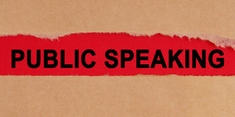 Among the torn sheets of paper on a red background, the inscription - Public Speaking
