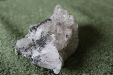 close-up of natural unprocessed rock crystal on a green background 