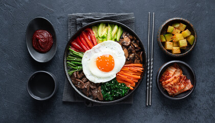  Bibimbap on a dark concrete background, traditional korean dish, top view