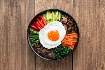  Bibimbap on a wooden background, traditional korean dish, top view