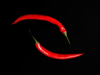 red hot chili peppers on the black background with selective focus
