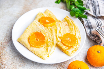 crepes citrus thin pancakes sweet dessert tangerine or tangerines breakfast healthy meal food snack on the table copy space food background rustic top view