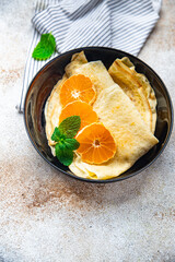 crepes citrus thin pancakes sweet dessert tangerine or tangerines breakfast healthy meal food snack on the table copy space food background rustic top view