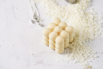 Tools and supply for candle-making: wicks, soy and coconut wax, gold foil, colors and aroma oils, bubble candle