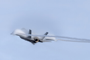 Very unusual close view of a F-35C  in a high G maneuver , with condensation clouds over the wings...