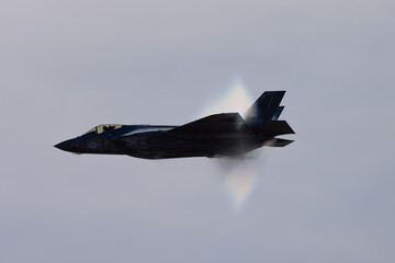 Very unusual close view of a F-35C Lightning II  at very high speed, with condensation cone...