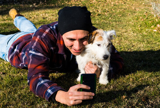 Teenager posing for a selfie with a cute Jack Russel Terrier in outdoor