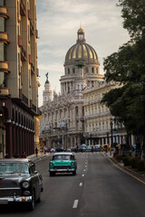 Old car on streets of Havana with Capitolio building in background. Cuba