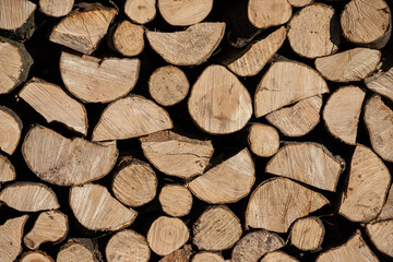 Pile of stacked triangle firewood prepared for fireplace and boiler