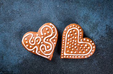 Heart shaped gingerbread cookies on blue background, top view. Mothers day dessert. Womens day dessert. Romantic present.