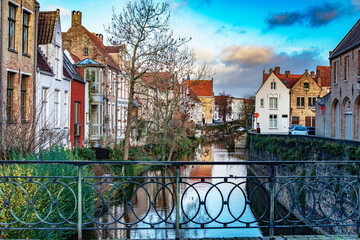 View of historical city of Bruges at West Flanders province in Belgium. Inner canals surrounded by old historical buildings. 