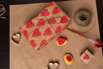 heart shaped potato stamp on craft paper. The process of decorating a gift for Valentine's Day....