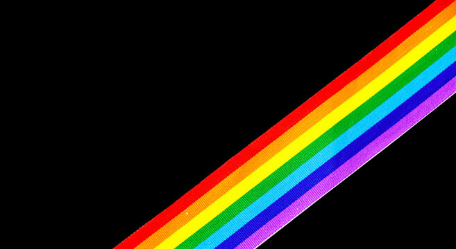 Colorful rainbow ribbon border design. LGBT colourful corner design, isolated on black background. Gay pride design. Ribbon or banner with flag of LGBTQ pride border