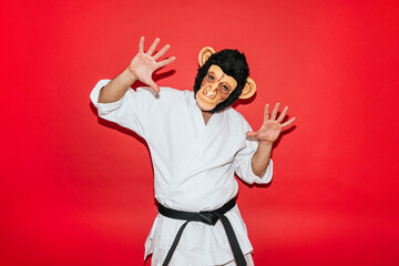 Man with monkey mask practicing martial arts.