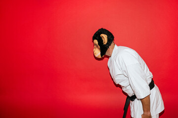 Man with monkey mask practicing martial arts.
