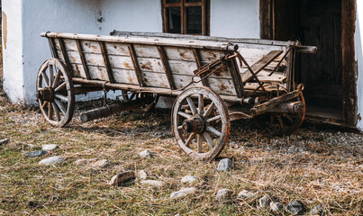 Fototapeta na wymiar Scenic landscape with old farm wagon in front of a house