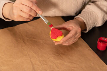 heart shaped potato stamp on craft paper. The process of decorating a gift for Valentine's Day. Getting ready for the celebration on February 14th.