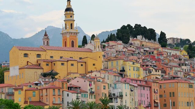 Cityscape of Menton, France. Traditional residential buildings, Basilica St. Michel