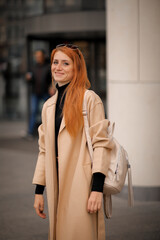 Obraz premium woman walking down the street. walk through the autumn city 