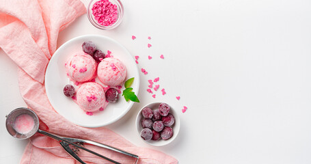 Three ice cream balls with frozen cherries and hearts on a white background.