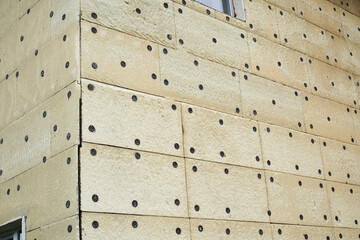 Close-up of the insulation of a residential building. Exterior repair work on the building, insulation and cladding of the facade of the house. High quality photo