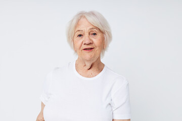 portrait of smiling elderly woman white t-shirt isolated background