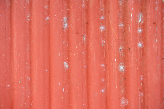 Red sheet metal, old, stained, corrugated with vertical lines. roofing