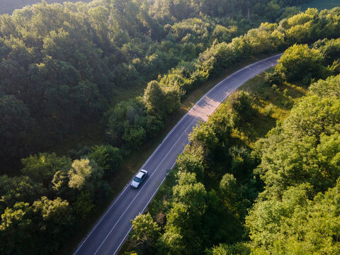 Aerial view on Highway road in the forest. View from a drone. Ca
