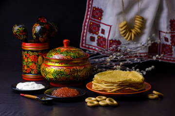 Traditional Russian food and symbols on dark background for Maslenitsa festival.