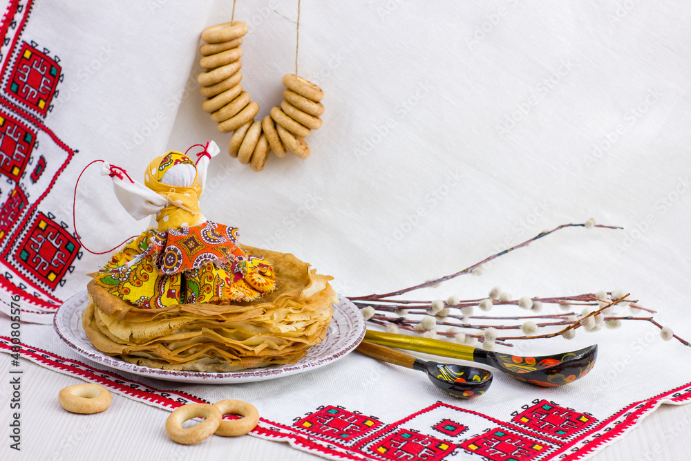 Wall mural Background with pancakes, textile doll, wooden spoon, rushnik , sushki and pussy-willow for Maslenitsa festival.