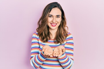 Young hispanic girl wearing casual clothes smiling with hands palms together receiving or giving gesture. hold and protection