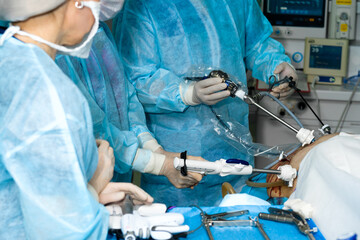 Hands of surgeons with laparoscopic surgical manipulators. Selective accent. Minimally invasive...